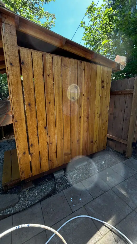 “Deck staining Salem OR – freshly stained wood deck and fence by Three Star Painting in Salem.